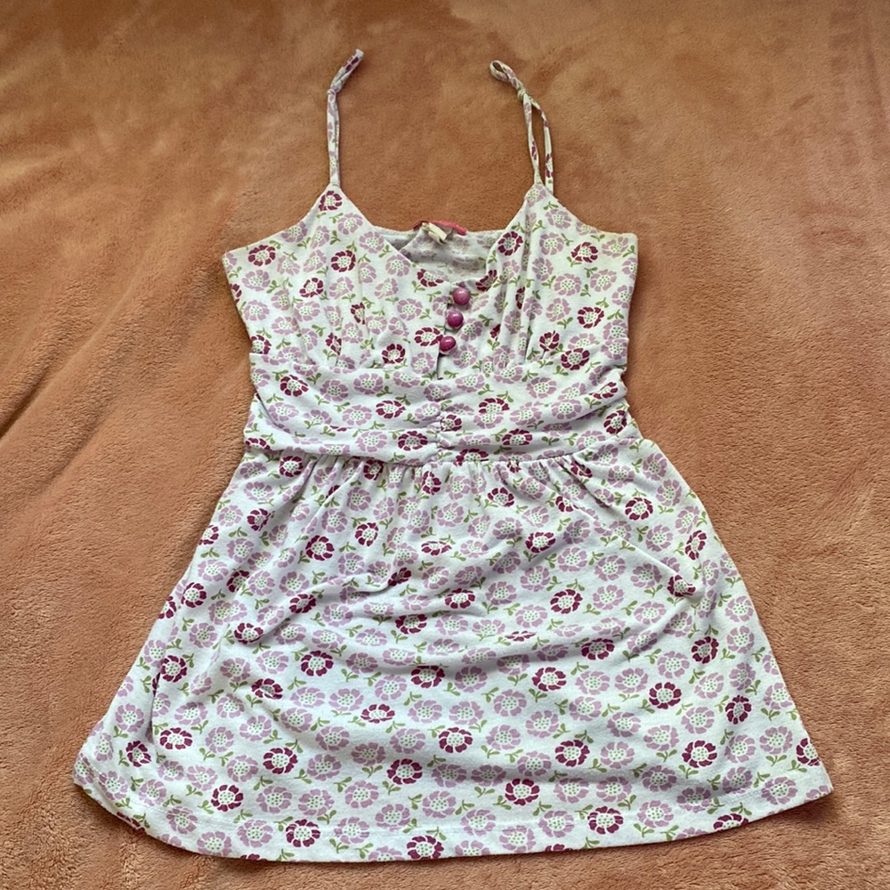 White tank top with buttons with light purples and dark purple flowers